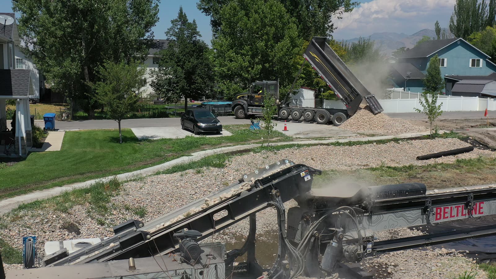 Beltline telescoping conveyor placing gravel on a residential job site in Northern Utah