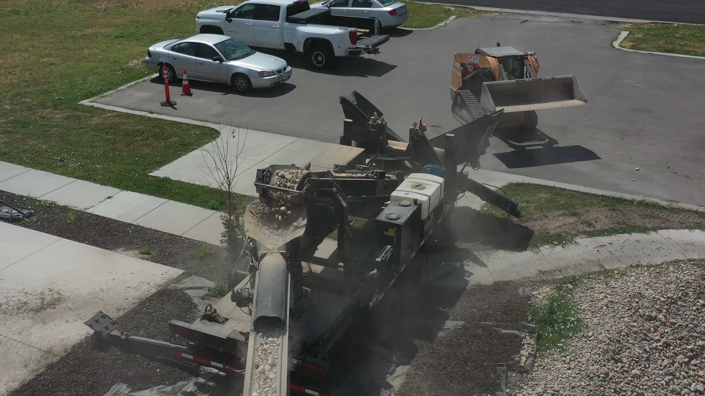 Overhead view of the conveyor placing gravel into a trench