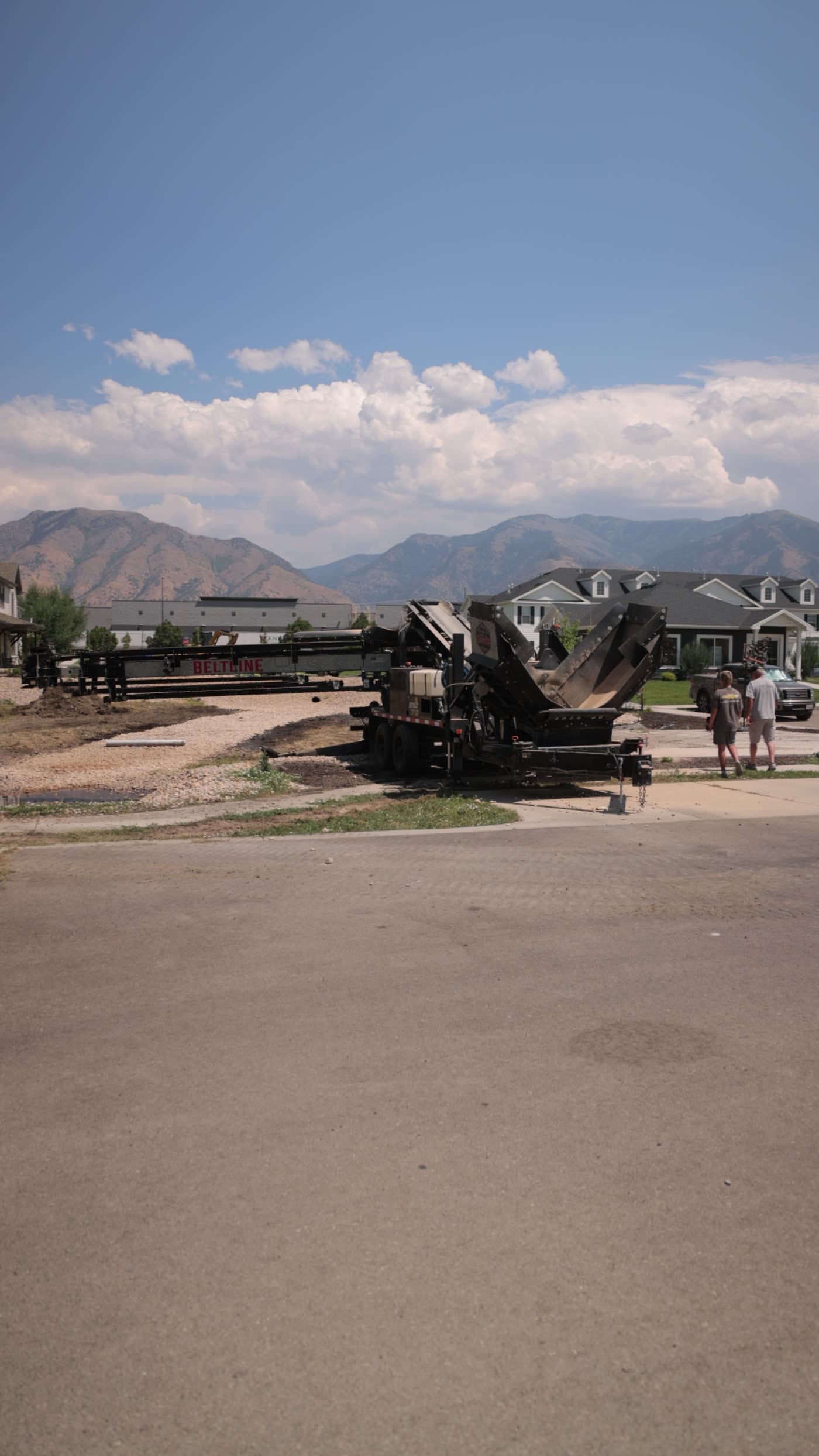 Residential street in Northern Utah with the Wasatch mountains behind the job site
